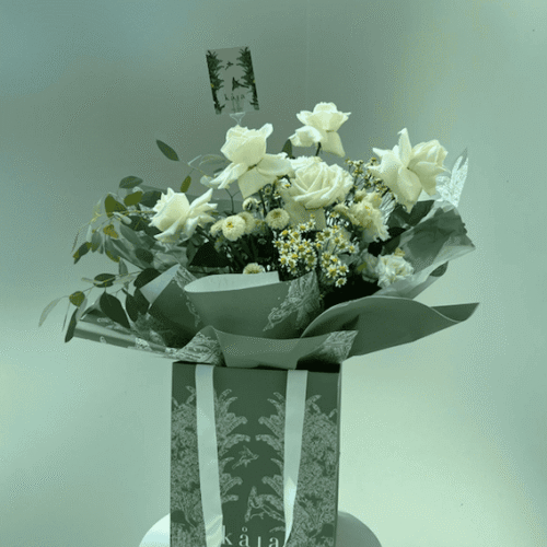 white aura floral bag arrangement