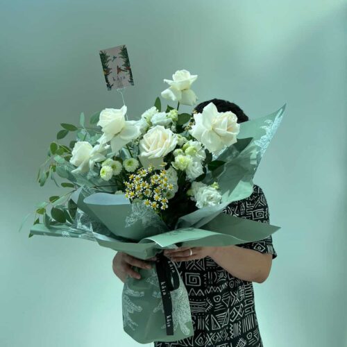 Alternative view of white aura floral bag arrangement