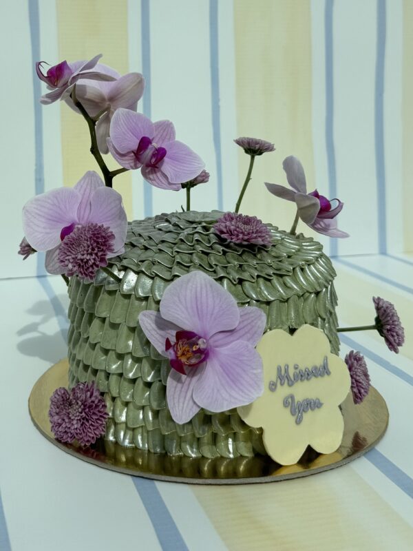 Elegant orchid-themed cake decorated with pink and purple orchids, perfect for special occasions and floral celebrations.