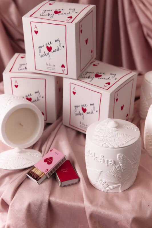 Beautiful Love Candle Gift Set featuring heart-themed packaging and a white candle, perfect for romantic occasions and gift-giving, displayed on soft pink fabric.