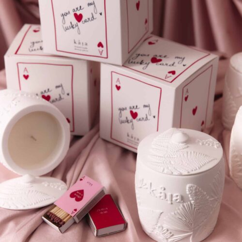 Beautiful Love Candle Gift Set featuring heart-themed packaging and a white candle, perfect for romantic occasions and gift-giving, displayed on soft pink fabric.