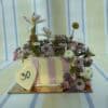 Beautiful floral cake decorated with fresh flowers including lilies, daisies, and roses, featuring a heart-shaped topper with the number 30, perfect for milestone celebrations.