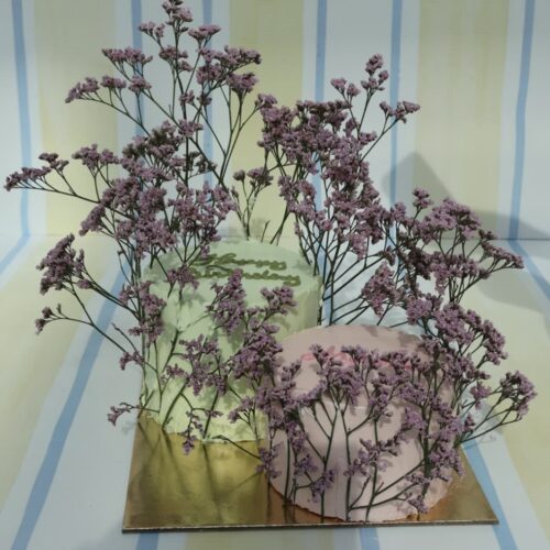 Beautiful purple flowers arranged in vases, perfect for home decor or special occasions, showcasing fresh and vibrant floral designs.