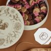 Elegant gift box filled with assorted chocolate florals in pink, brown, and beige, perfect for special occasions or as a luxurious treat.