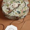 Decorative round gift box featuring a detailed squirrel and nature scene, perfect for elegant gift presentation.